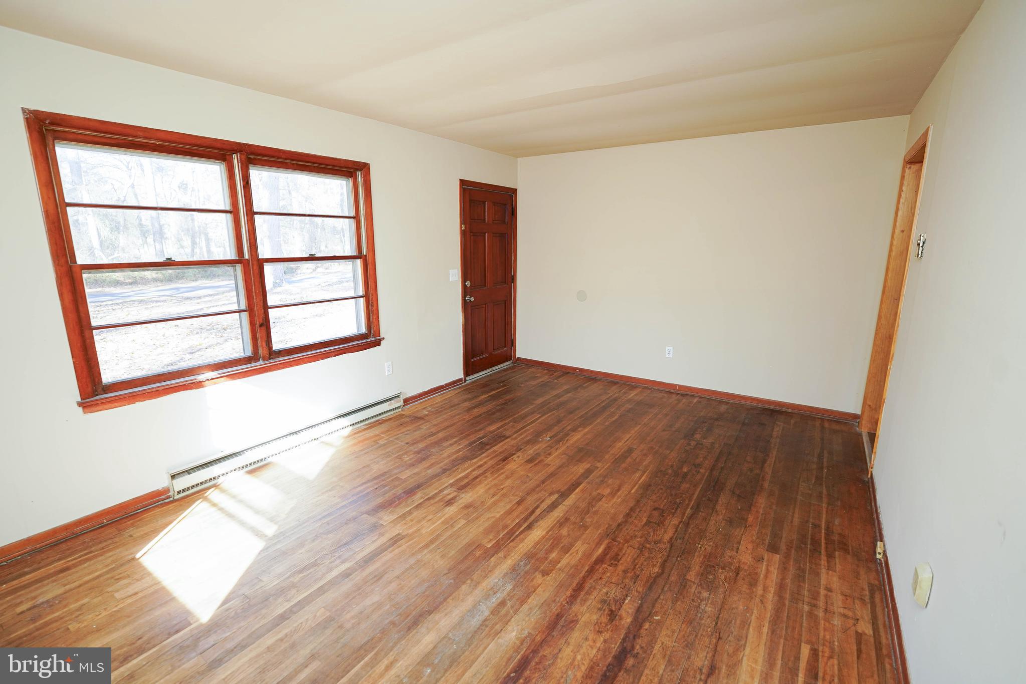 5643 Rip Wil Drive Salisbury, MD 21804 - Photo 10 of 34 an empty room with wooden floor and windows
