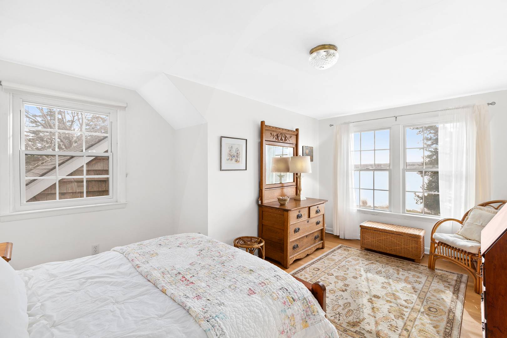 69 Ferry Road Sag Harbor, NY 11963 - Photo 13 of 17 a spacious bedroom with a bed and glass window