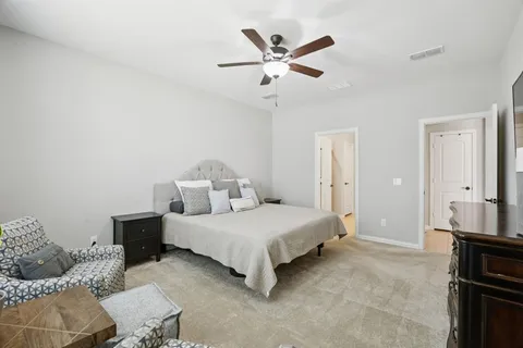 a bedroom with a bed couch and window