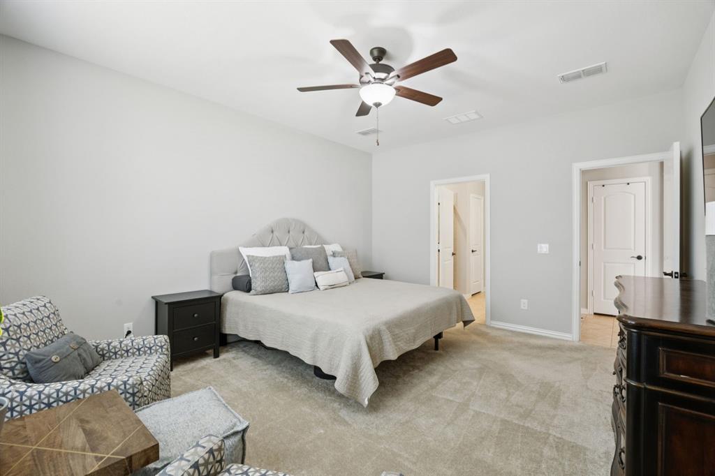 2448 Jack Rabbit Way Northlake, TX 76247 - Photo 18 of 40 a bedroom with a bed couch and window