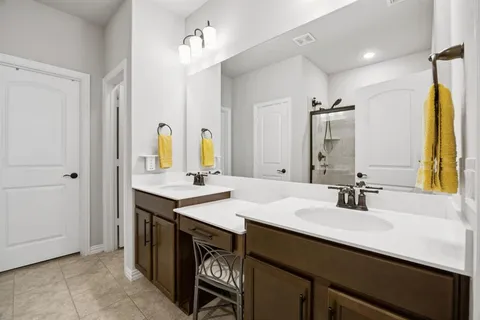 a bathroom with a sink double vanity and a mirror