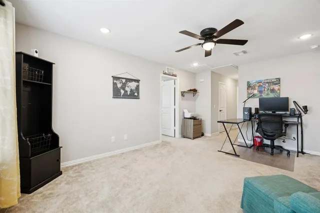 a view of a livingroom with workspace and a window