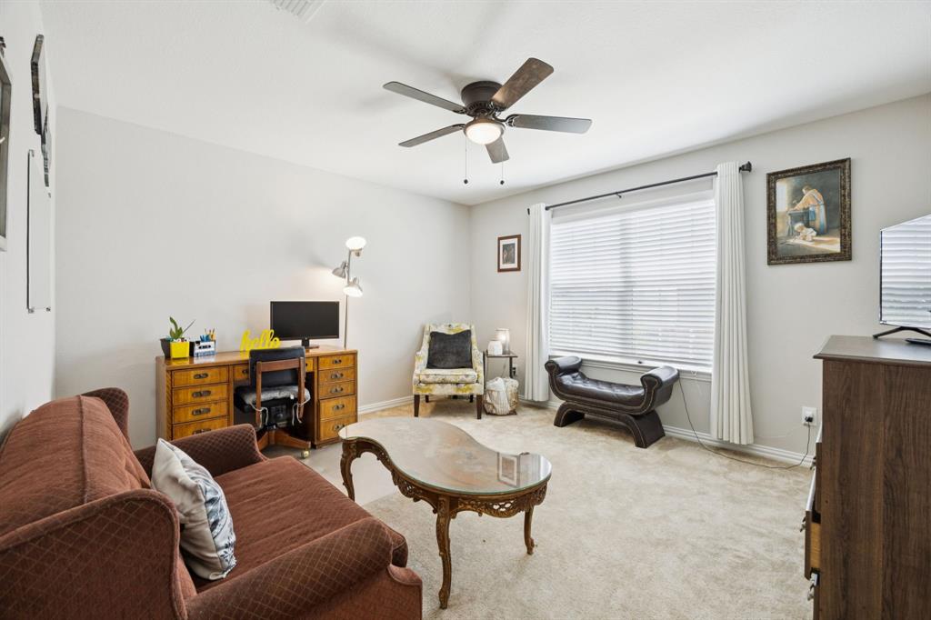 2448 Jack Rabbit Way Northlake, TX 76247 - Photo 23 of 40 a living room with furniture and a flat screen tv
