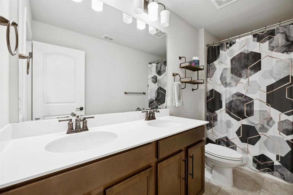 2448 Jack Rabbit Way Northlake, TX 76247 - Photo 24 of 40 a bathroom with a sink vanity mirror and toilet