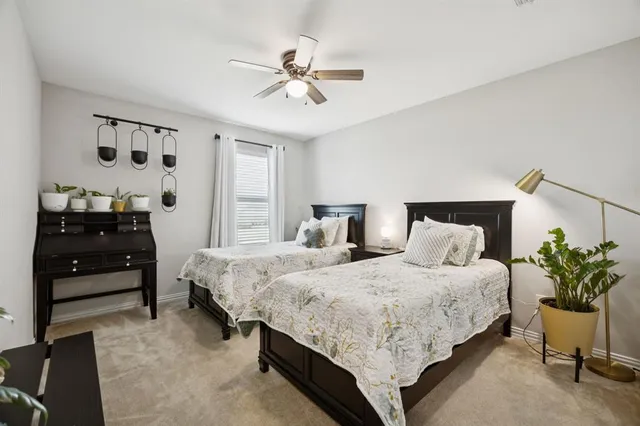 a bedroom with bed and a chandelier