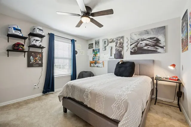 a bedroom with a bed and wall painting