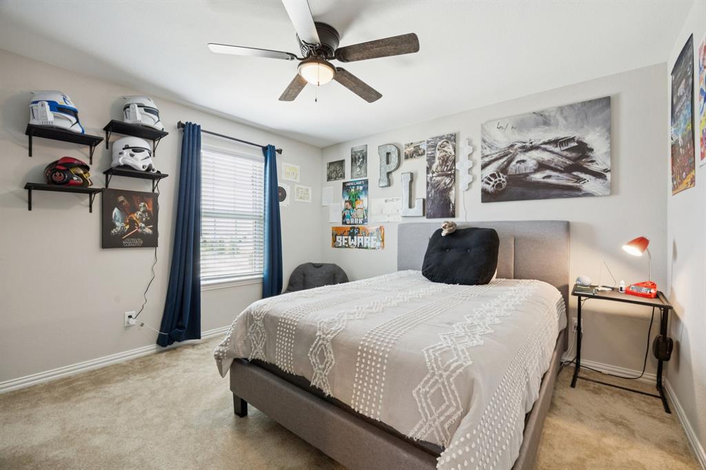 2448 Jack Rabbit Way Northlake, TX 76247 - Photo 27 of 40 a bedroom with a bed and wall painting