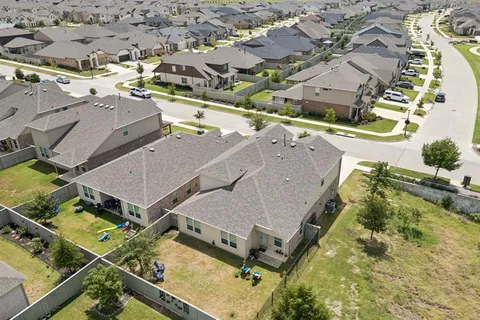 an aerial view of a house with a yard