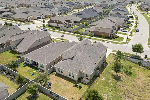 an aerial view of a house with a yard
