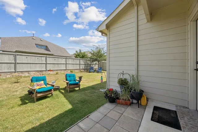 a view of a chairs and table in patio
