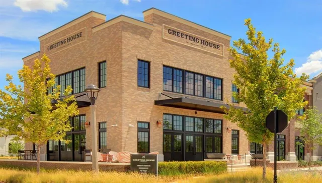a backyard of a house with table and chairs