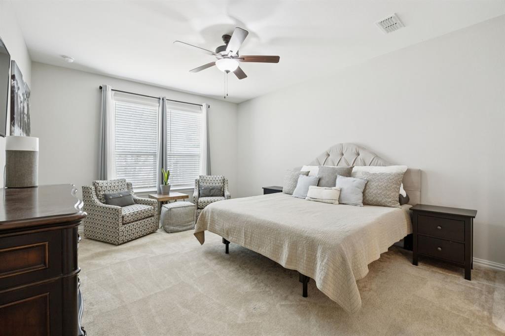 2448 Jack Rabbit Way Northlake, TX 76247 - Photo 5 of 40 a bedroom with a bed and a chandelier