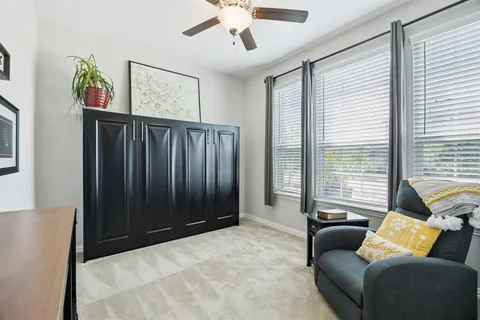 a living room with furniture and windows