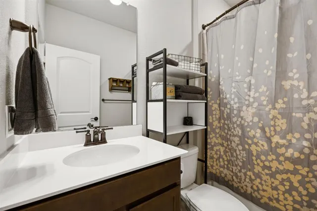 a bathroom with a sink toilet and shower