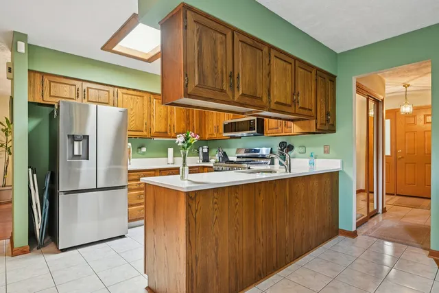 a kitchen with stainless steel appliances granite countertop a refrigerator and a sink