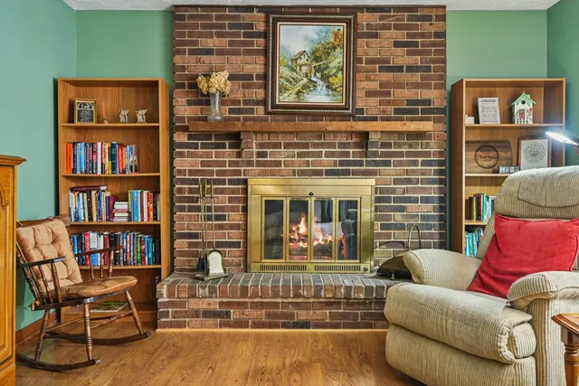 a living room with fireplace furniture and a book shelf