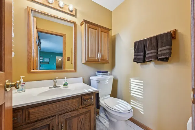 a bathroom with a sink a toilet and mirror