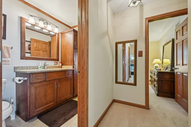 a bathroom with a granite countertop sink a mirror and a