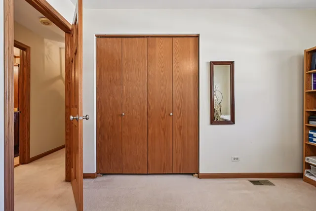 a spacious bedroom with a bed and a chandelier