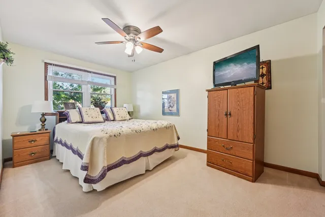 a bedroom with a bed chair and a window