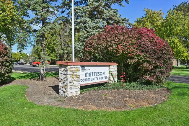a view of a backyard with large trees