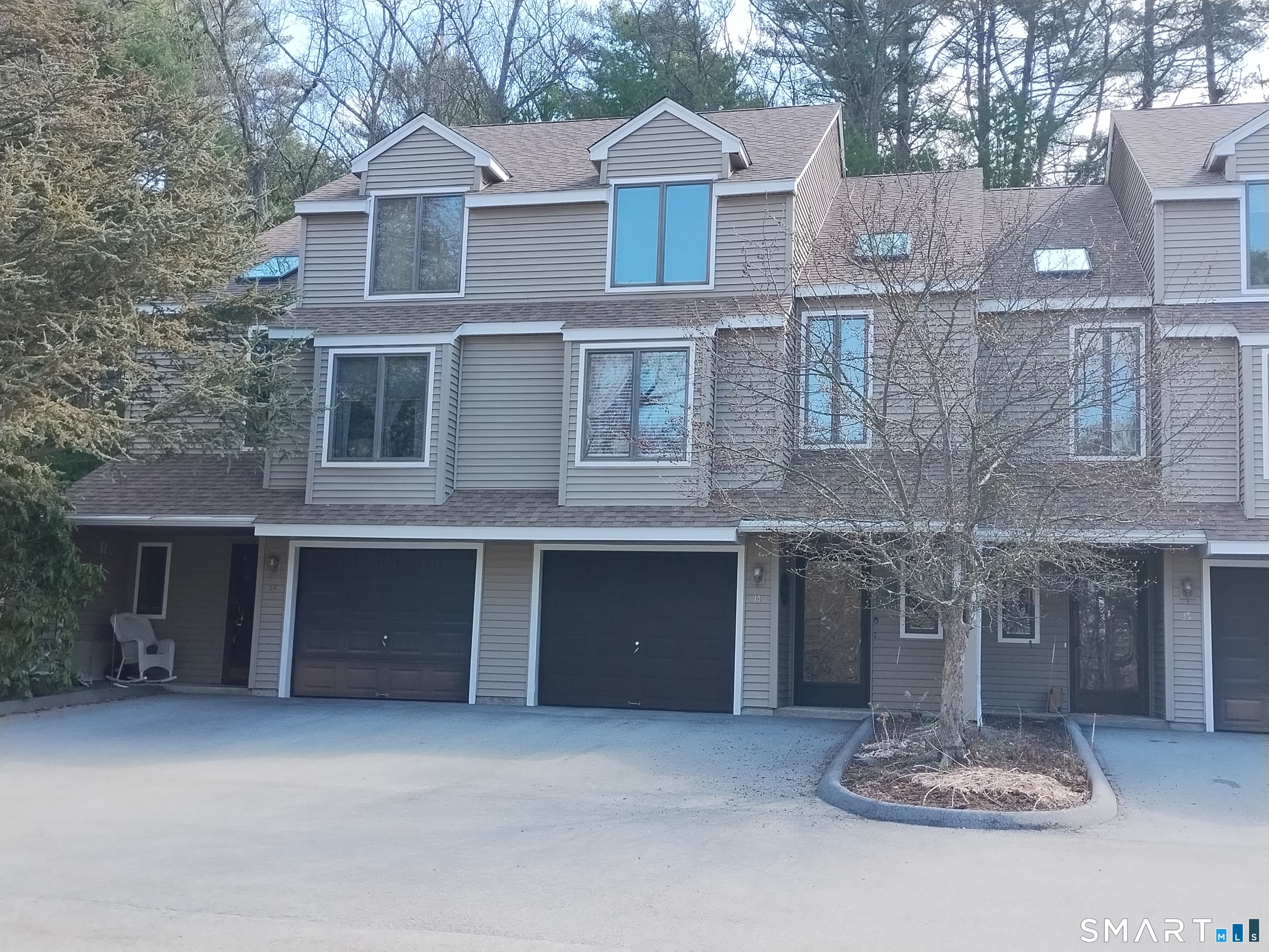 3 Westside Drive, Unit 14 Thompson, CT 06255 - Photo 1 of 22 a front view of a house with a yard and garage