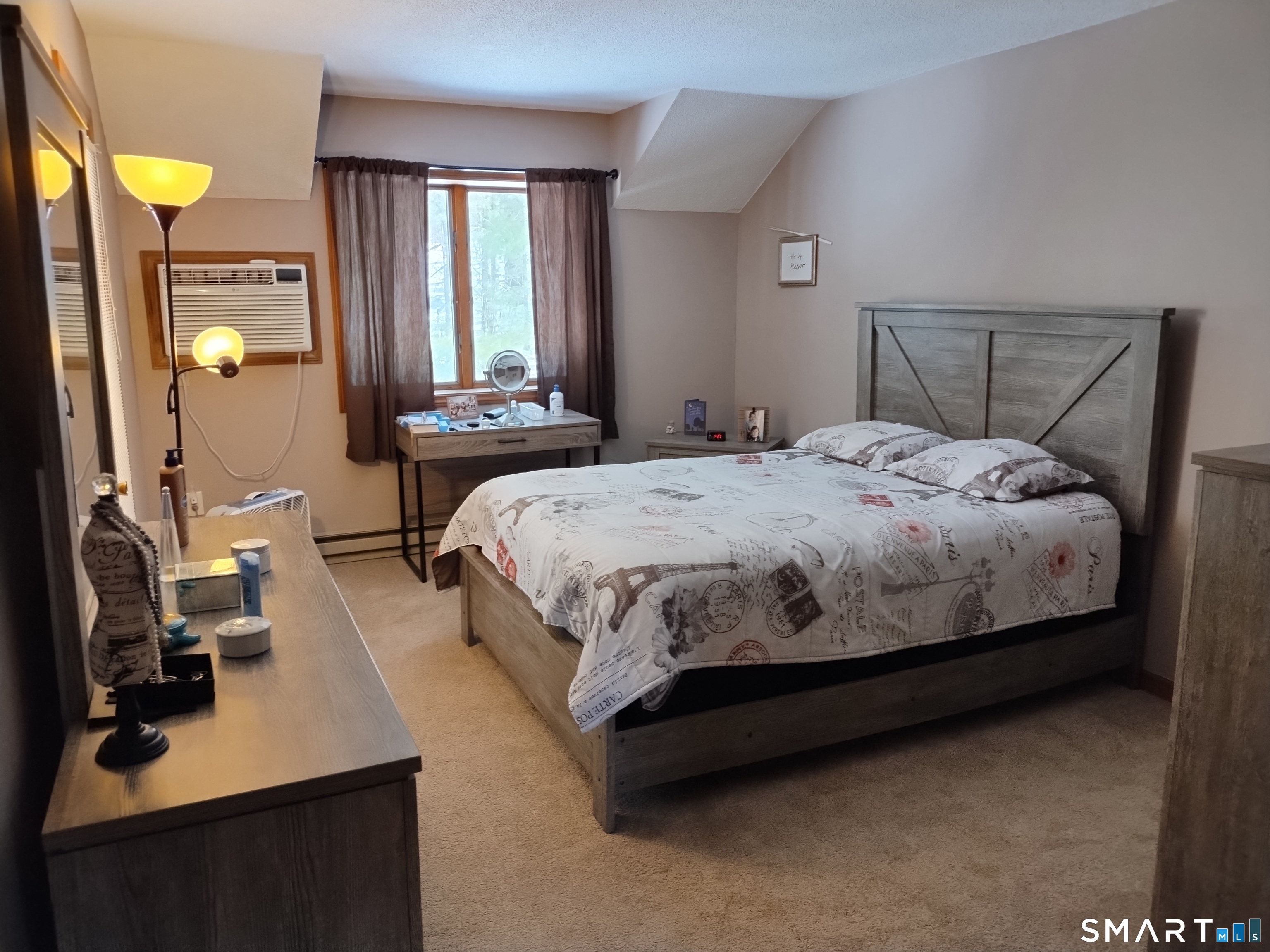 3 Westside Drive, Unit 14 Thompson, CT 06255 - Photo 16 of 22 a bedroom with a bed lamp and a large window