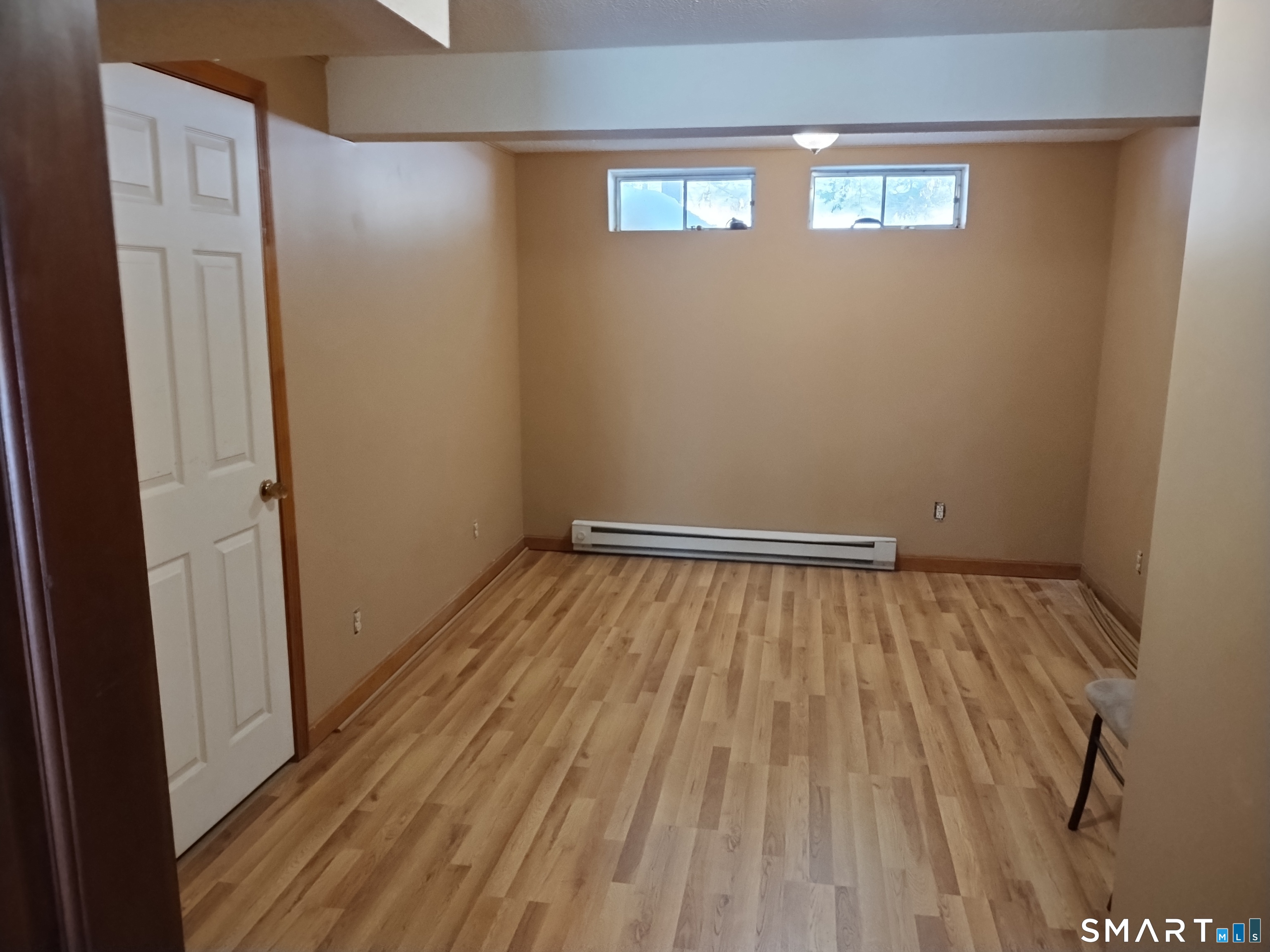 3 Westside Drive, Unit 14 Thompson, CT 06255 - Photo 21 of 22 a view of an empty room with wooden floor and a window
