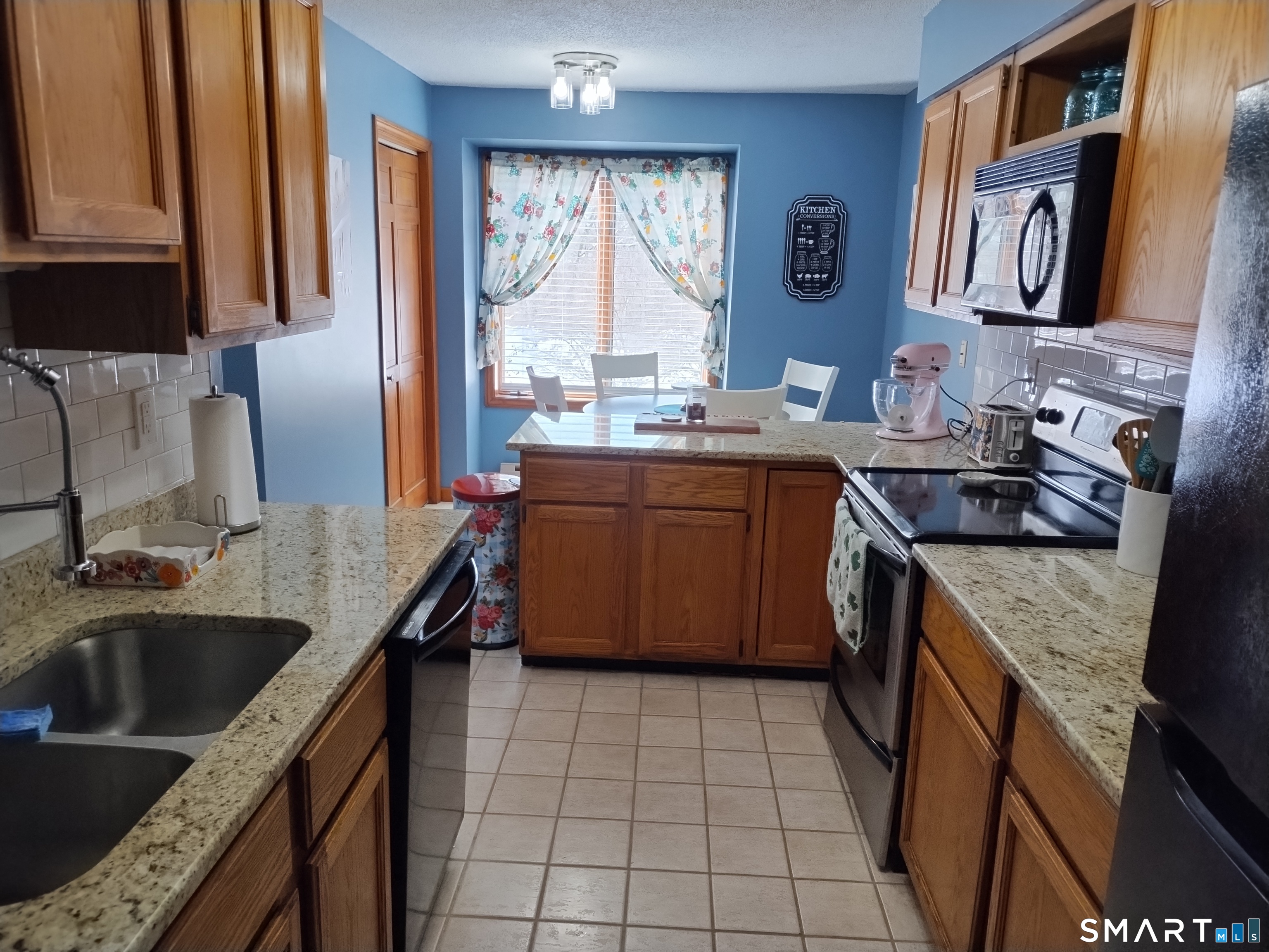 3 Westside Drive, Unit 14 Thompson, CT 06255 - Photo 6 of 22 a kitchen with a sink stove top oven and cabinets
