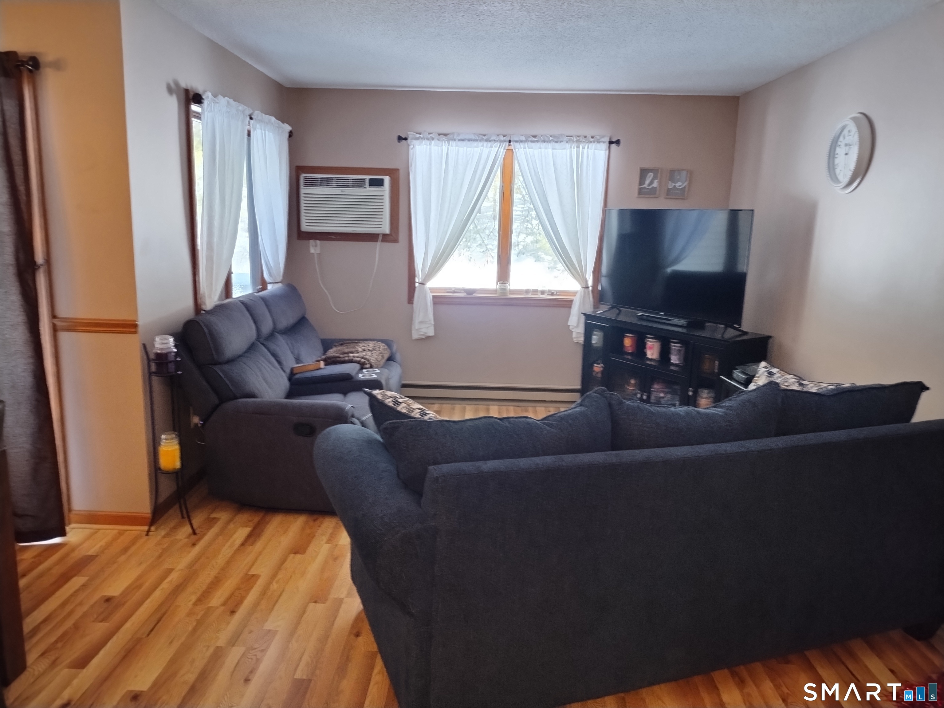 3 Westside Drive, Unit 14 Thompson, CT 06255 - Photo 10 of 22 a living room with furniture and a flat screen tv
