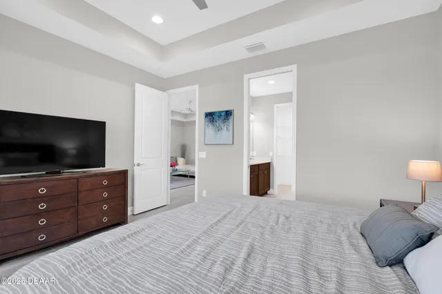 a bedroom with a bed and flat screen tv