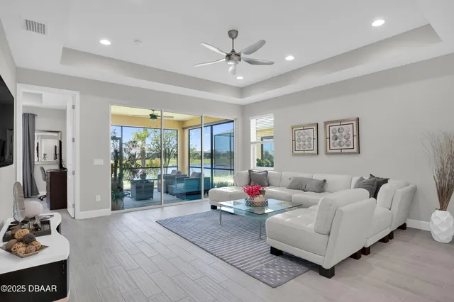 a living room with furniture and large windows