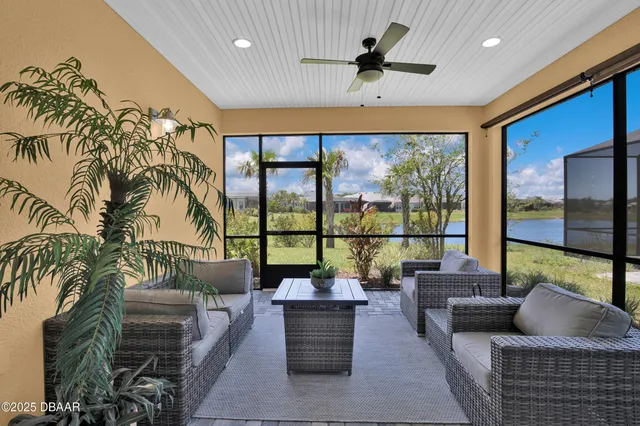 a living room with furniture tv and a large window