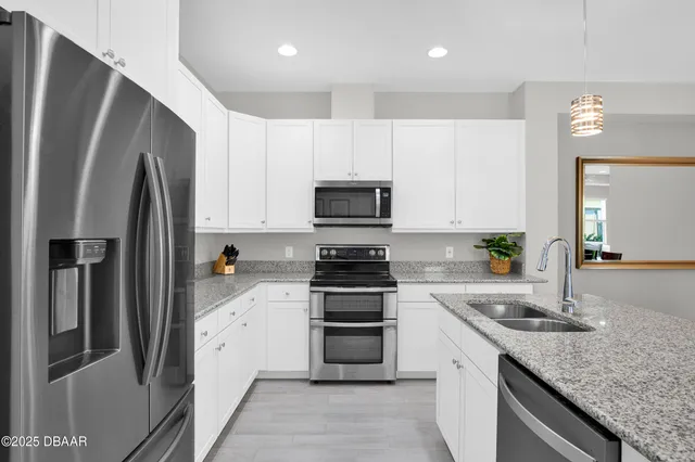 a kitchen with a sink stove and refrigerator