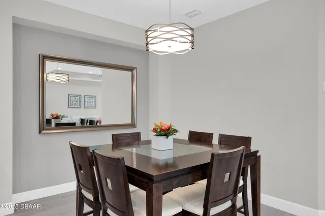 a dining room with a table and chairs