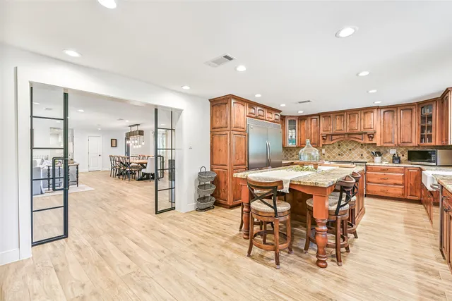 a view of a a dining room and livingroom with furniture window and wooden floor