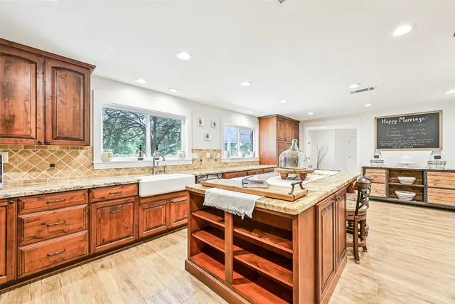 a kitchen with granite countertop white cabinets and white appliances
