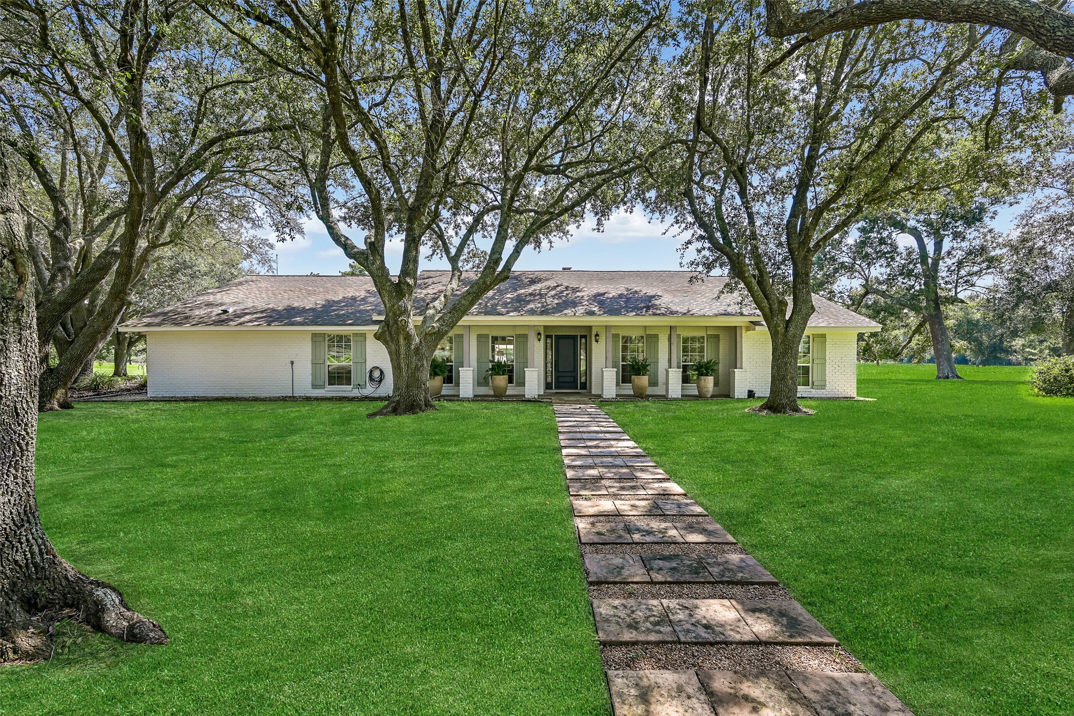 3042 Poskey Road Anahuac, TX 77514 - Photo 2 of 50 a front view of a house with a yard