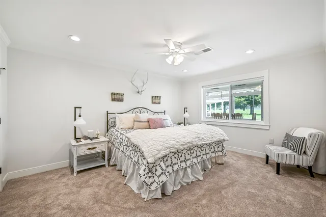 a bedroom with a bed and a table in it with window