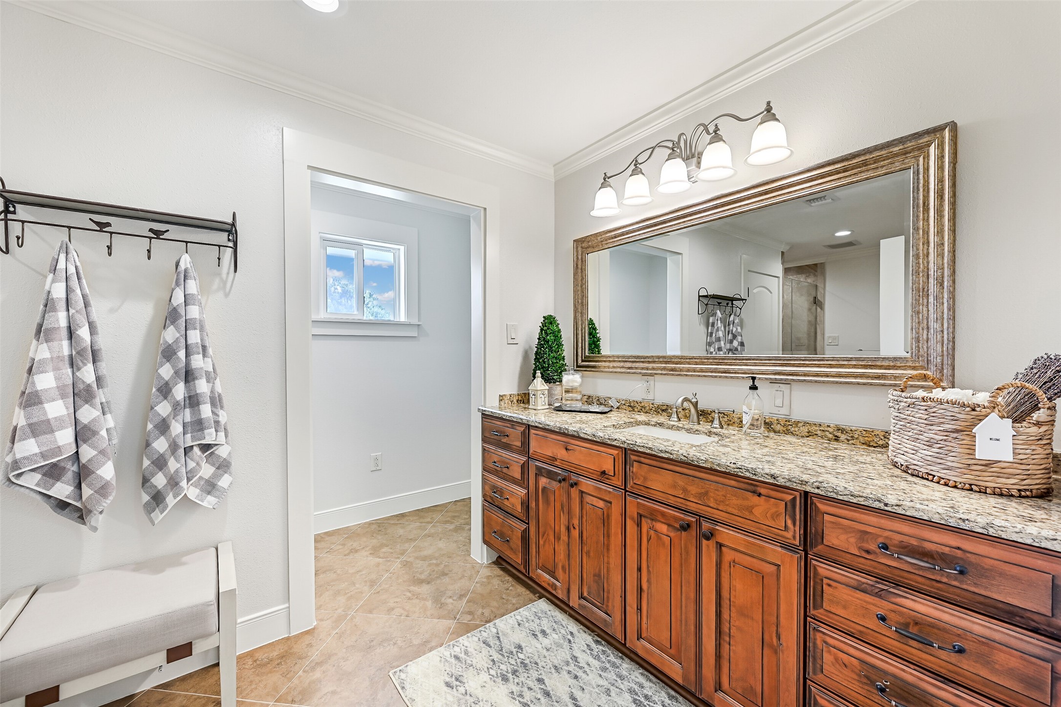 3042 Poskey Road Anahuac, TX 77514 - Photo 26 of 50 Luxurious en-suite bathroom featuring a spacious vanity with elegant granite countertops.