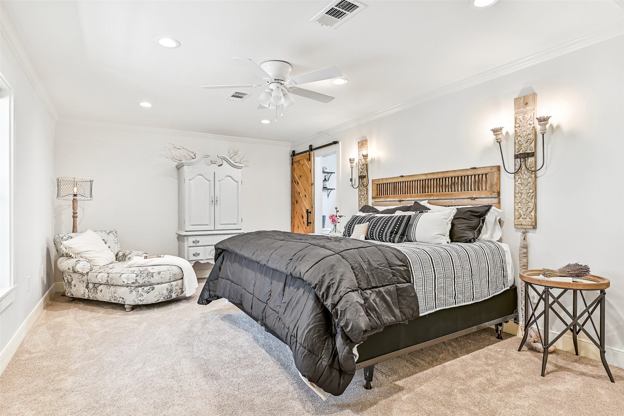 3042 Poskey Road Anahuac, TX 77514 - Photo 29 of 50 a spacious bedroom with a bed and ceiling fan