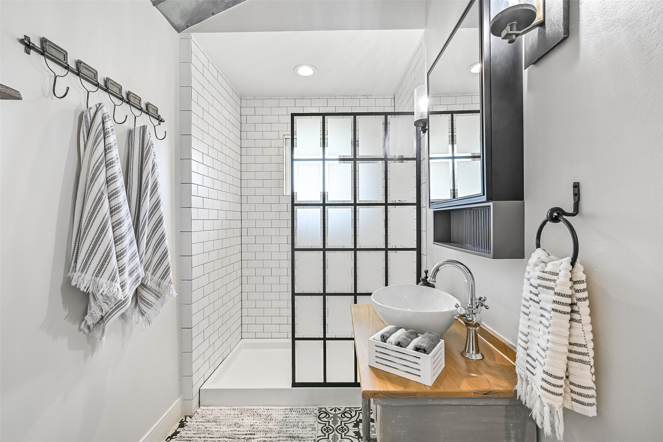 3042 Poskey Road Anahuac, TX 77514 - Photo 30 of 50 Experience luxury in this elegant bathroom featuring a sleek glass-enclosed shower, stylish tiling, a modern showerhead, and a convenient built-in niche.