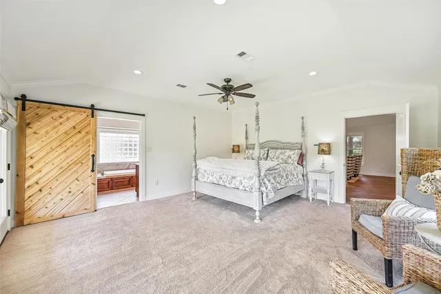 a bedroom with a bed couch and window