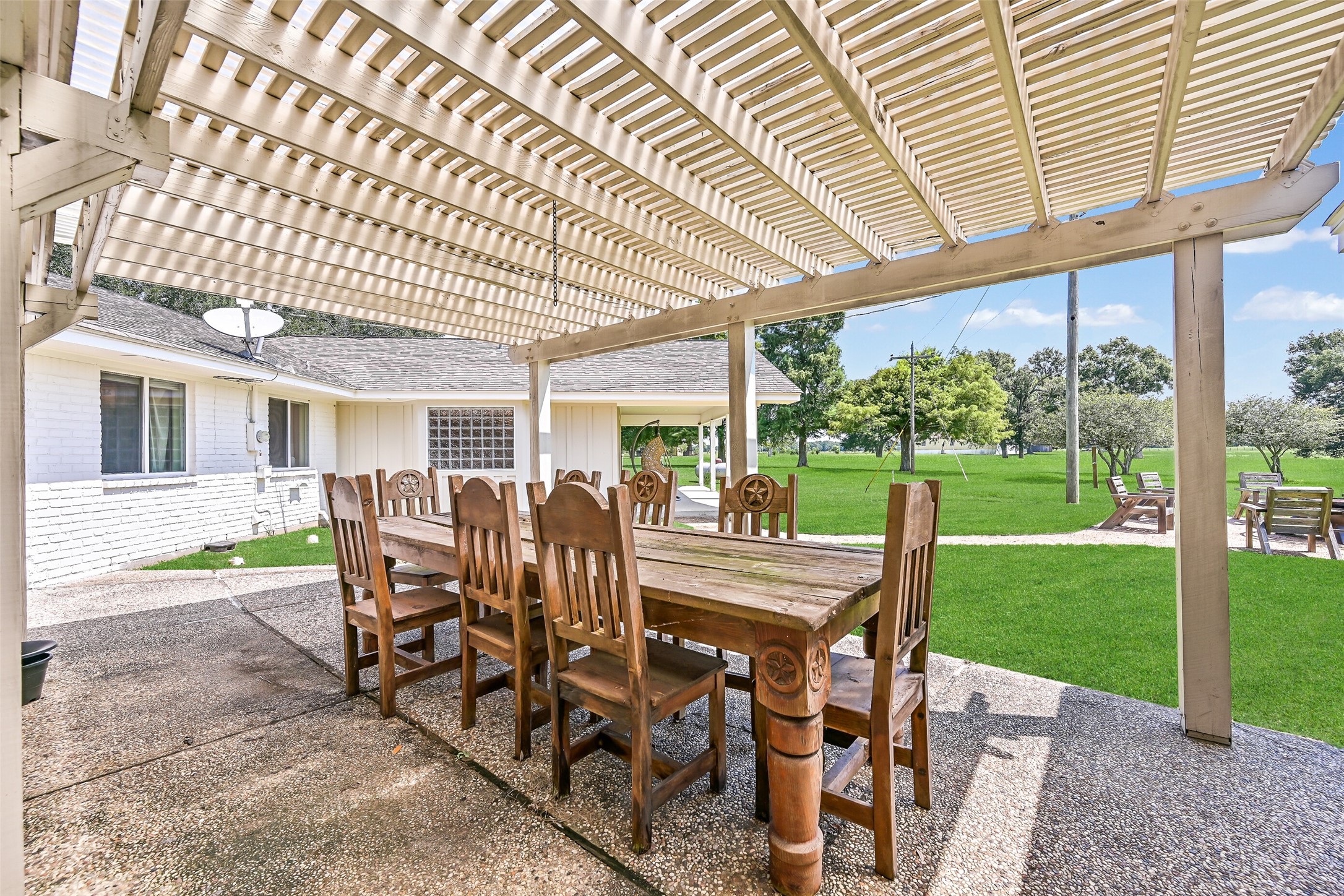 3042 Poskey Road Anahuac, TX 77514 - Photo 38 of 50 a view of a patio with a table chairs and backyard