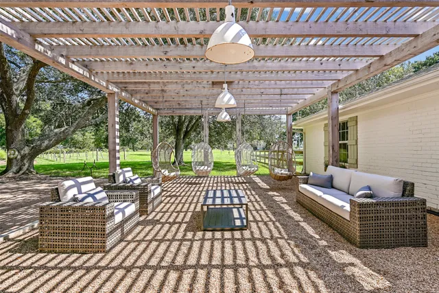 a view of a patio with a table chairs and backyard