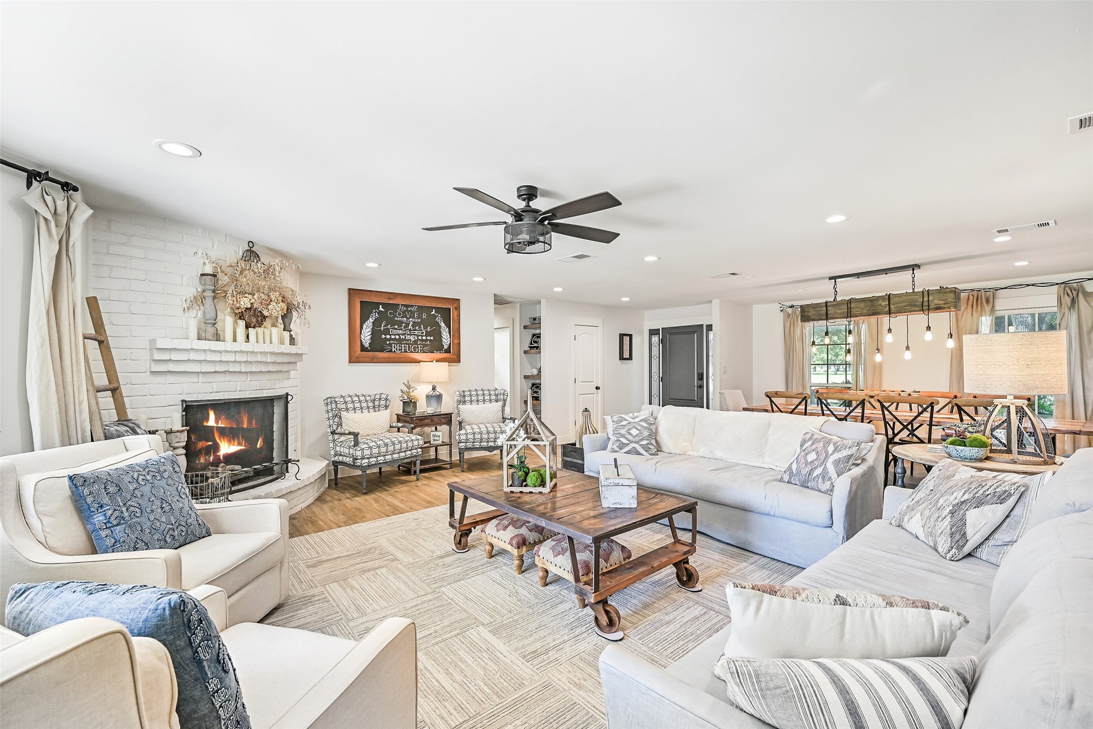 3042 Poskey Road Anahuac, TX 77514 - Photo 50 of 50 a living room with furniture a fireplace and a chandelier