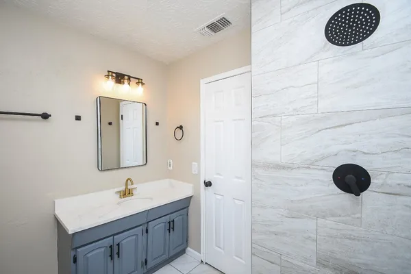 a bathroom with a sink and a mirror