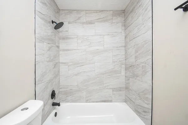 a bathroom with a shower and bathtub