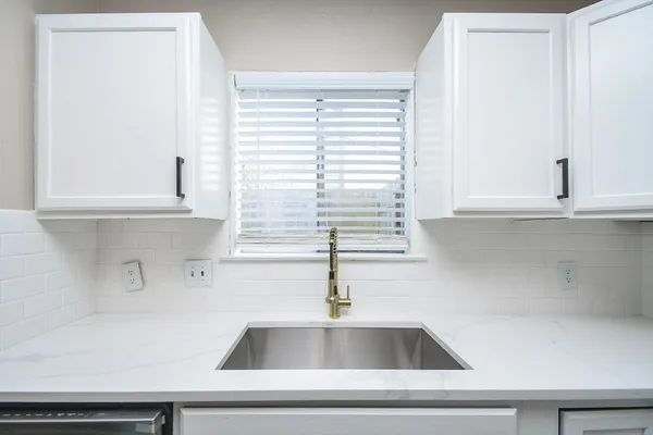a close view of sink and cabinets