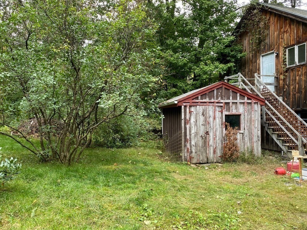 9 Deer Run Path Heath, MA 01346 - Photo 19 of 32 a house with green field in front of it